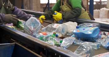 Sorting home recyclable materials at a recycling center